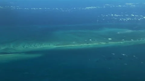 Flying across Atlantic Ocean with long strip of turquoise water surface Vídeo Stock 333507233