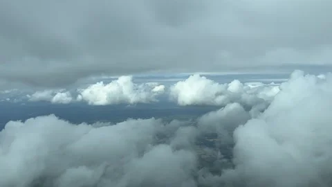 Flying across a partially cloudy sky with some tiny white clouds. A Stock Footage 246901188