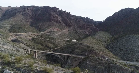 Flying across top of mountains looking at cars below drone aerial 4K Stock Footage 111311964