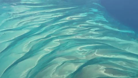 Flying across turquoise water surface and a small atolls in The Bahamas Video stock 333507258