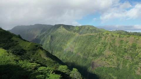 Flying across valley towards a rainbow on Mount Aorai, Tahiti French Polynesia Stock Footage 253171760