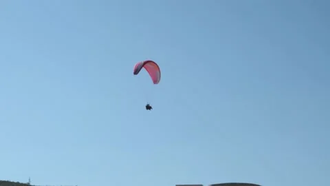 Flying against the background of the blue sky, a steam plane In the city near Stock Footage 201546755