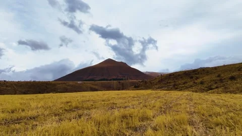 Flying against the mountains and fields in cloudy weather Stock Footage 293699183