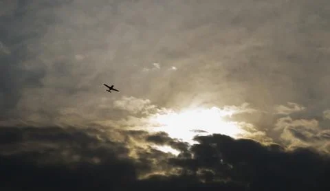 Flying airplane with dramatic sky Stock Photos