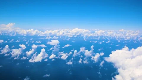 Flying in airplane over Atlantic ocean and clouds showing Earth's atmosphere Stock Footage 80804458