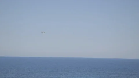 Flying airplane on the sea Stock Footage 87033379