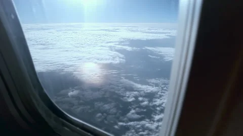 Flying in an airplane, view of the ground with clouds Stock Footage 267705369