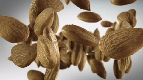Flying of Almonds in Dark Grey Background Stock Footage 147483404