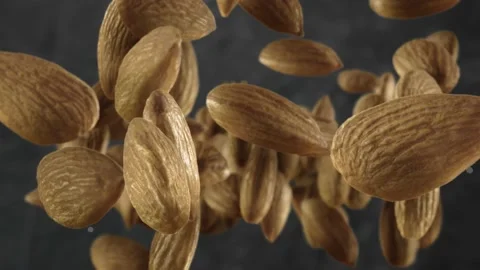 Flying of Almonds in Dark Kitchen Background Stock Footage 147483809