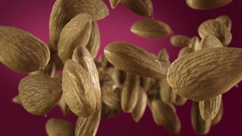 Flying of Almonds in Deep Fuchsia Background Stock Footage 147483366