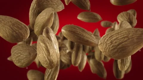 Flying of Almonds in Deep Red Background Stock Footage 147484682