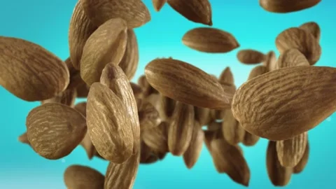 Flying of Almonds in Ice Blue Background Stock Footage 147483254