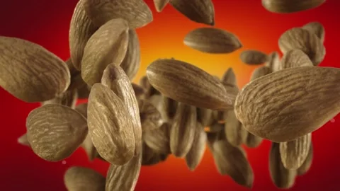 Flying of Almonds in Red Background Stock Footage 147483756
