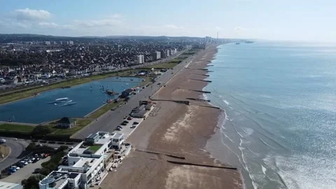 Flying along above the beach at Shoreham-by-Sea Stock Footage 195822067