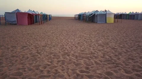 Flying along beach awnings on the Atlantic coast Stock Footage
