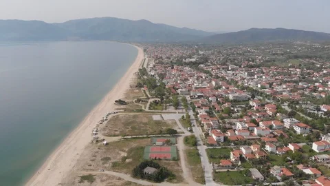 Flying along the beach in a small town in Greece Stock Footage 107441116