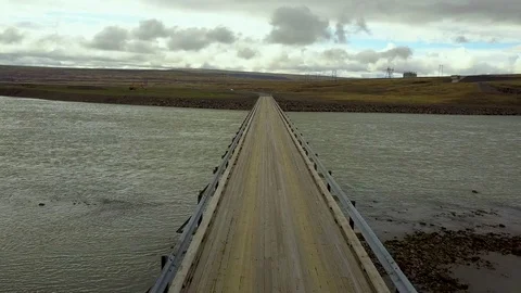 Flying along a bridge over a wide river in Iceland Stock Footage 102411316