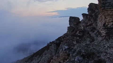 Flying along the cliff with traces of weathered rock against the background of a Stock Footage 150569936
