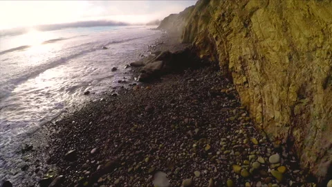 Flying along cliffs as marine layer blows in Malibu Beach Drone Stock Footage 174903395