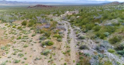 Flying Along Desert Trail with Mountains in Background Video stock 114775813