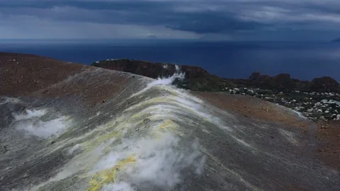 Flying along the edge of a volcano, viewn of Vulcano town Stock Footage 121294914