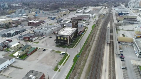 Flying Along Empty Railroad Tracks by Industrial Area During Day Stock Footage 131847736