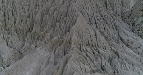 Flying along eroded mountain slope with abstract drawings of water erosion 스톡 동영상 103494764
