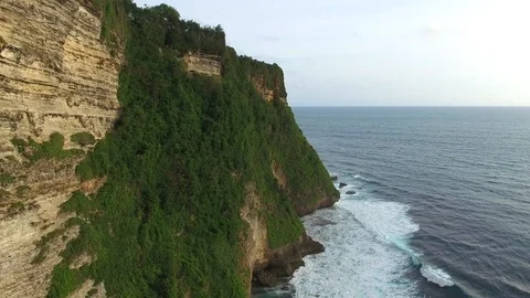 Flying along high cliffs of rocky ocean shore Stock Footage 108676693