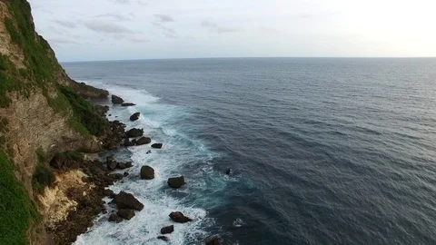 Flying along high cliffs of rocky ocean shore Stock Footage 108677308