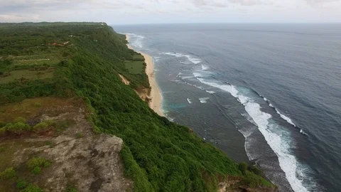 Flying along high cliffs of rocky ocean shore 動画素材 108677474