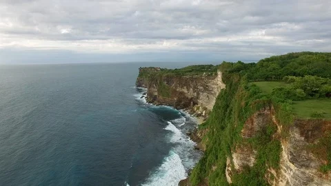 Flying along high cliffs of rocky ocean shore Stock Footage 108679045