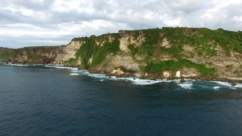 Flying along high cliffs of rocky ocean shore Stock Footage 108679129
