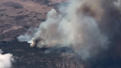 Flying along a huge forest fire in a wooded mountain region, with massive smoke  Stock-Footage 341278785