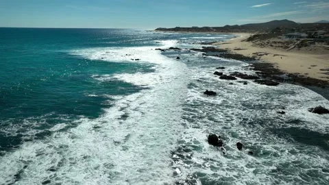 Flying along long rolling waves in mid day sun Stock Footage 236742166