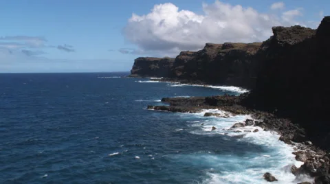 Flying along Molokai's rocky shoreline near the surf. Shot in 2010. Stock Footage 59362321