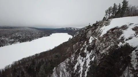 Flying along mountainside between lakes Stock Footage 100135952