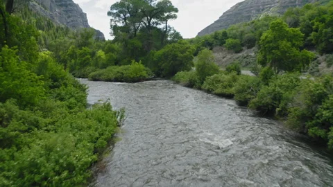 Flying along Provo River bend with the flow of the current, slow motion, Utah Stock Footage 248174462