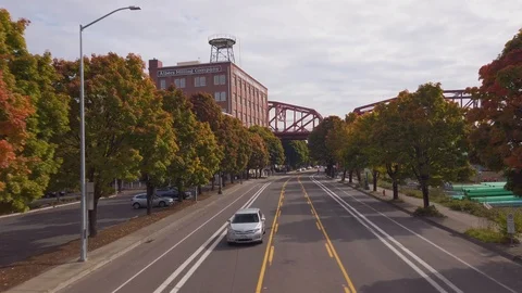Flying along road with one passing car and gradually moving up to the same Stock Footage 118443815