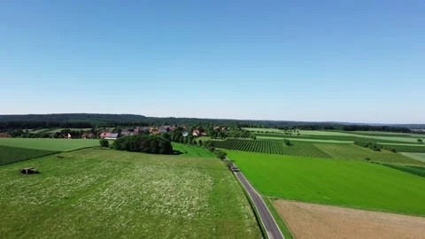 Flying along the road to a small town Stock Footage 155934389