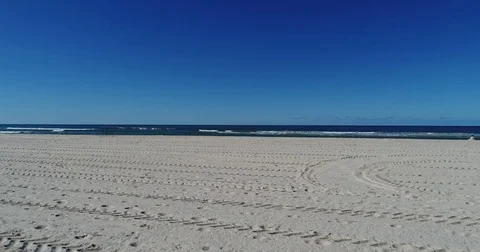 Flying along the sand at the beach by drone 4K Stock Footage 74943539