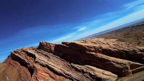 Flying along a scenic interstate route surrounded by rugged desert mountains Vídeos de archivo 331769567