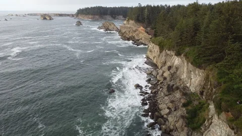 Flying Along Sunset Cliffs Over Ocean Waves Crashing on Rock Islands, Lighthouse Stock Footage 225616847