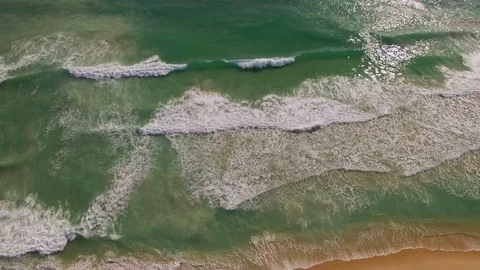 Flying along surf breaking on a beach Stock Footage 94675168