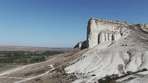 Flying along a wall of white rock White limestone rock formed by the shift of Stock Footage 115265837