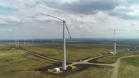 Flying along the wind farm on a cloudy day Video stock 153445215