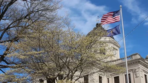 Flying American and Indiana Flags by Court House Stock Footage