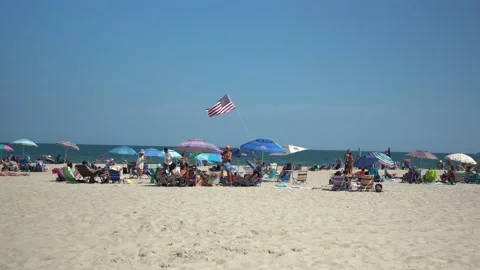Flying American Flag on beach Stock Footage 140999848