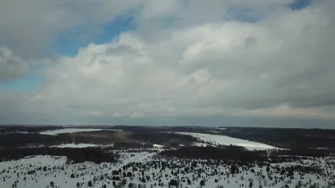Flying among the clouds over the forest in winter Stock Footage 109004705