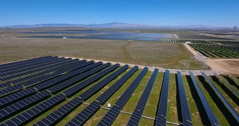 Flying up and away from solar panel farm in grassy field Stock Footage 104812113