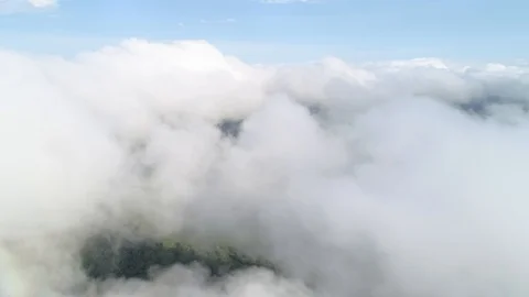 Flying and climbing through a layer of cumulus clouds. Plain rural landscape Stock Footage 118051020